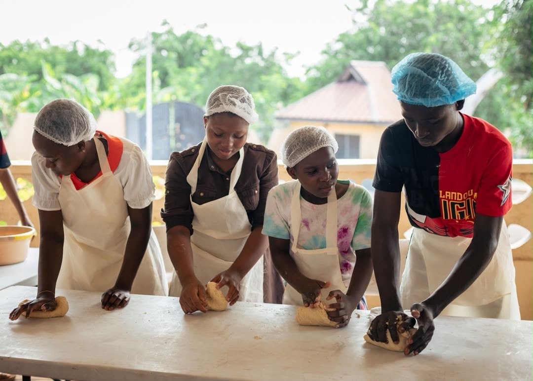 Children learning to bake at a Turning Olive Charity workshop